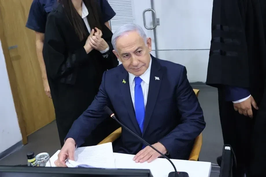 Government official seated at desk with microphone
